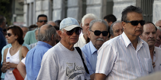 The first customers, most of them pensioners, stand in a queue to enter a branch at National Bank of Greece headquarters in Athens, Monday, July 20, 2015. Greek banks reopen on Monday morning, but many restrictions on transactions, including cash withdrawals, will remain. Also, many goods and services will become more expensive as a result of a rise in Value Added Tax approved by Parliament last Thursday, among the first batch of austerity measures demanded by Greece's creditors. (AP Photo/Thanassis Stavrakis)