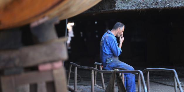 ATHENS, GREECE - JULY 08: A shipyard worker takes a break as he works on the hull of a new ship being built in a Perama shipyard on July 8, 2015 in Athens, Greece. The town of Perama on the outiskirts of Piraeus has been building ships for centuries but has suffered immensely during the recent economic slowdown with the local area suffering 90% unemployment. Eurozone leaders have offered the greek government one more chance to propose a viable solution and rescue of it's debt or face the possibilty a likely exit from the euro. (Photo by Christopher Furlong/Getty Images)