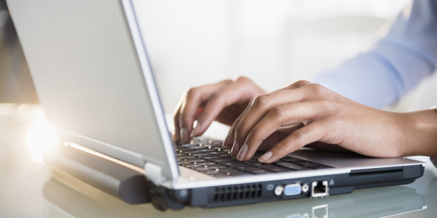 Mixed race businesswoman working on laptop