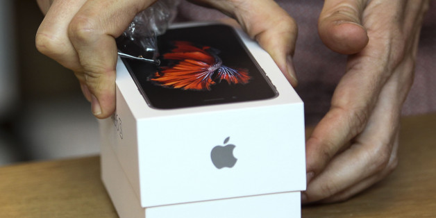 A customer tries out his Apple iPhone 6s smartphone Friday, Sept. 25, 2015 at the Apple store at The Grove in Los Angeles. Apple is counting on sales of the new iPhones to maintain its position as one of the most profitable, and valuable, companies in the world. (AP Photo/Ringo H.W. Chiu)