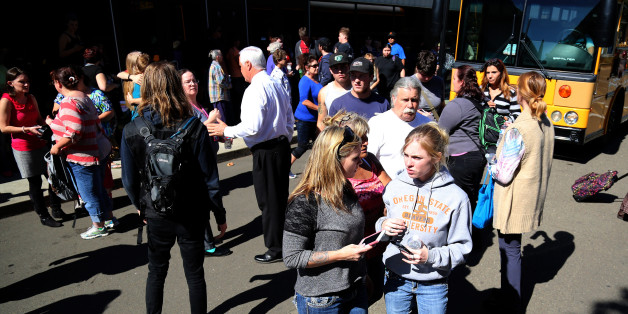 Friends and family are reunited with students at the local fairgrounds after a mass shooting at Umpqua Community College, in Roseburg, Thursday, Oct. 1, 2015. Multiple people were killed after a gunman opened fire at the campus early Thursday. (AP Photo/Ryan Kang)