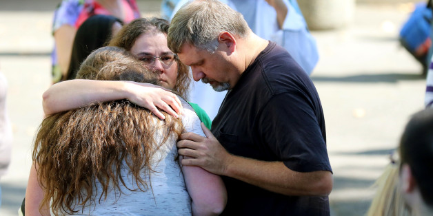 Friends and family are reunited with students at the local fairgrounds after a deadly shooting at Umpqua Community College, in Roseburg, Ore., Thursday, Oct. 1, 2015. (AP Photo/Ryan Kang)