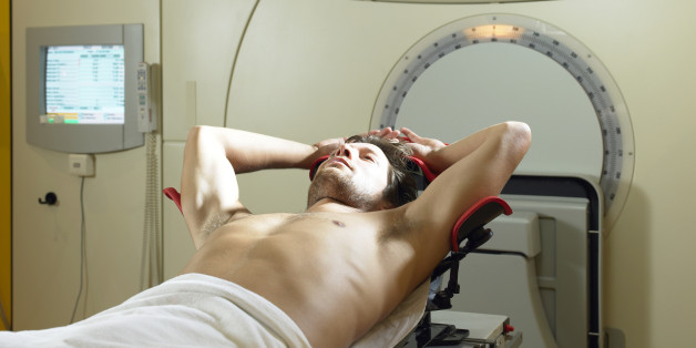 Young male patient lying on radiology bed