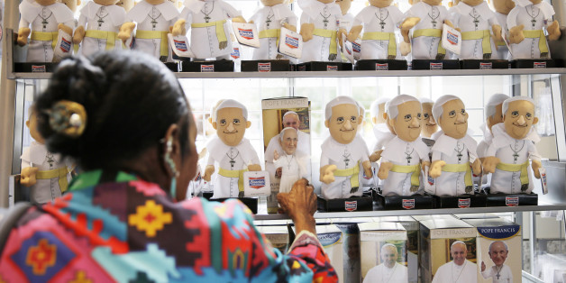 A women shops at the World Meeting of Families souvenir store ahead of Pope Francis' scheduled visit, Tuesday, Sept. 22, 2015, in Philadelphia. The World Meeting of Families which officially opened Tuesday is described by organizers as a conference that blends prayer, religious instruction and faith-themed lectures as the world's largest gathering of Catholic families. (AP Photo/Matt Rourke)
