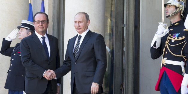 French President Francois Hollande, left, greets his Russian counterpart Vladimir Putin upon his arrival at the Elysee Palace in Paris, France, Friday, Oct. 2, 2015, Russian President Vladimir Putin is meeting the leaders of Ukraine, France and Germany in a revived European push to bring peace to eastern Ukraine. The long-awaited summit in Paris on Friday is being overshadowed by international concerns about Russia's military intervention in Syria this week. (AP Photo/Alexander Zemlianichenko)