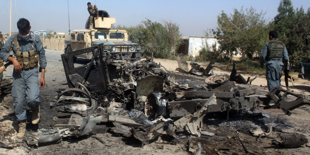 Afghan security forces inspect the site of a U.S. airstrike in Kunduz city, north of Kabul, Afghanistan, Friday, Oct. 2, 2015. The new leader of the Afghan Taliban says their capture of the northern city of Kunduz was a "symbolic victory" that showed the strength of the insurgency â even though the Taliban pulled out of the city after three days. (AP Photo)