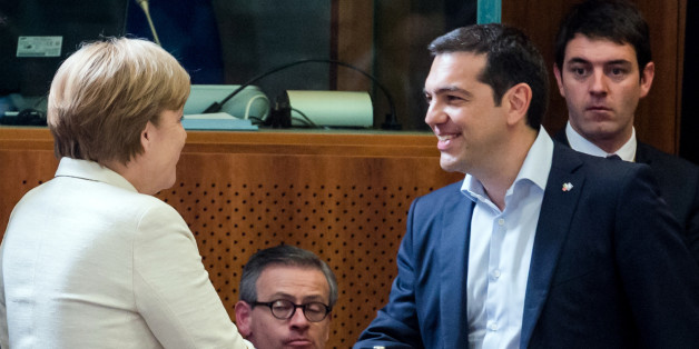 Greek Prime Minister Alexis Tsipras, right, shakes hands with German Chancellor Angela Merkel during a round table meeting at the EU-CELAC summit in Brussels on Wednesday, June 10, 2015. Greece's prime minister was hoping to meet with the leaders of Germany and France in Brussels Wednesday, in the latest effort to break a bailout negotiation deadlock that has revived fears his country could default and drop out of the euro. (AP Photo/Geert Vanden Wijngaert)