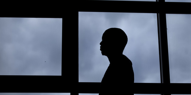 In this photo taken Thursday, Aug. 7, 2014, a 26-year-old gay Ugandan man, who insisted on anonymity because of fears for his safety, poses for a photograph after speaking to The Associated Press, in Nairobi, Kenya. When a Ugandan court overturned the country's Anti-Homosexuality Act this month, rights activists worldwide claimed a victory - but not gay Ugandans who fled persecution to live in a refugee camp in neighboring Kenya. (AP Photo/Ben Curtis)