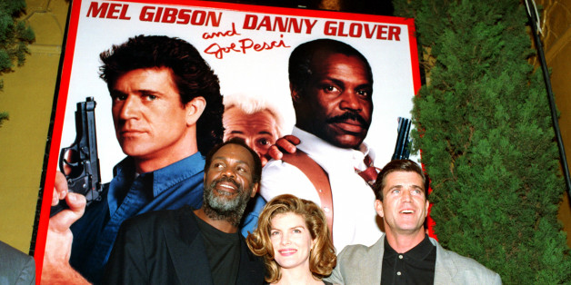 Co-stars Danny Glover, left, Rene Russo, center, and Mel Gibson pose in front of a "Lethal Weapon 3" poster at the movie's premiere at the Mann Village Theater in Westwood, Ca., Monday, May 11, 1992. (AP Photo/Reed Saxon)