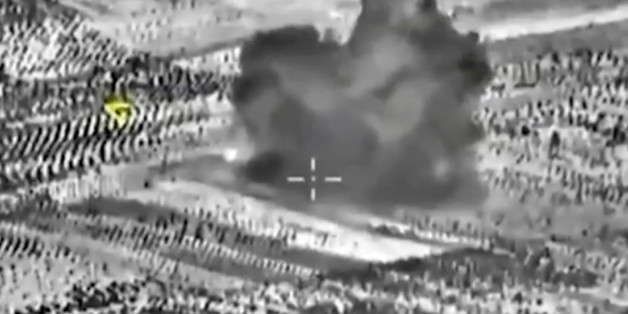 This image made from footage taken from Russian Defense Ministry official website on Friday, Oct. 2, 2015, shows another attack made from a fighter jet in Syria. The Russian Defense Ministry says its aircraft have carried out 18 sorties in Syria in the past 24 hours, including 10 overnight in which seven sites were bombed. The annotations on the image were made by the source and indicate the center of the target, and its direction, yellow. (AP Photo/ Russian Defense Ministry Press Service)