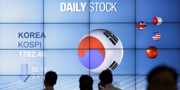 People walk past in front of the screen showing Korea Composite Stock Price Index (Kospi) in Seoul, South Korea, Friday, May 18, 2012. South Korea's Kospi lost 3.4 percent or 62.78 points at 1,782.46. Asian stocks dived Friday after discouraging U.S. economic reports unnerved investors already worried about the stability of the 17-country euro currency union. (AP Photo/Lee Jin-man)