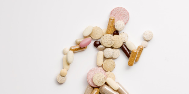 athletic runner shape made of vitamin pills viewed from above