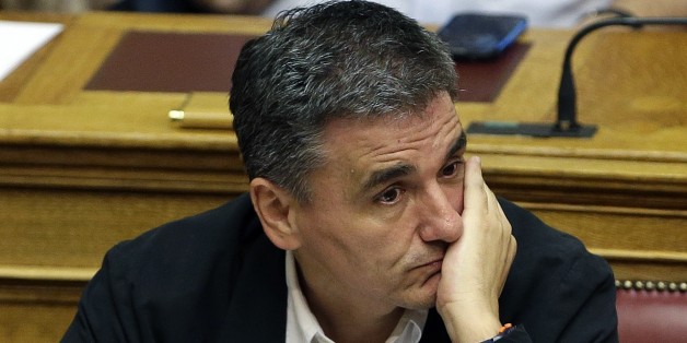 Greek Finance Minister Euclid Tsakalotos attends an emergency parliament session at the Greek Parliament in Athens, Wednesday, July 22, 2015. Greece's liquidity-starved banks got a new cash injection from the European Central Bank on Wednesday, hours before a key vote in parliament on further economic reforms demanded by international creditors in return for a third bailout. (AP Photo/Thanassis Stavrakis)