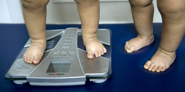 Colombian twins Juan Manuel and John Anderson Giraldo are weighed in a nutritionist office on September 22, 2011 in Medellin, Antioquia department, Colombia. The twins are 18 months old and weigh 16 kilos, while their ideal weight should be 11 kilos. The latest results from the Colombian National Health and Nutrition Situation reveal that infant obesity is on the rise, with one in six children between the ages of 5 to 17 considered to be overweight or obese. AFP PHOTO/Raul ARBOLEDA (Photo credit