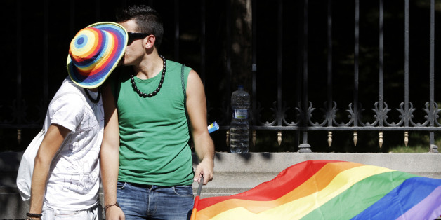 A couple kiss each other during the EuroPride parade in Madrid, Saturday, June 30, 2007. Spain, predominantly Roman Catholic, had for centuries been under the moral guardianship of the church. Homosexuality was decriminalized in 1979 and today Spain has some of the most liberal gay rights legislation in the world allowing same sex couples to adopt children and making a legislation that made homosexual rights equal to those of heterosexuals in areas including inheritance and workplace benefits. (AP Photo/Daniel Ochoa de Olza)