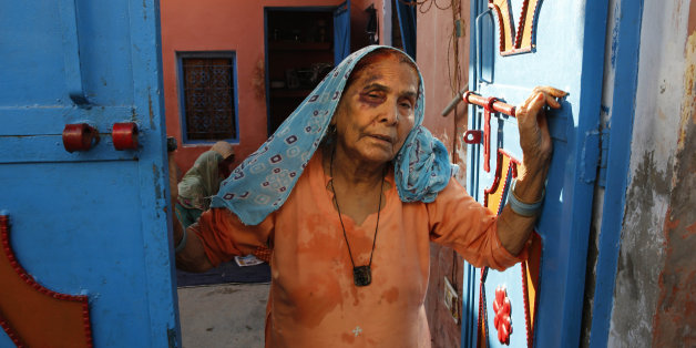 A bruised Asgari Begum, mother of 52-year-old Muslim farmer Mohammad Akhlaq, stands by the entrance of her home in Bisara, a village about 45 kilometers (25 miles) southeast of the Indian capital of New Delhi, Wednesday, Sept. 30, 2015. Indian police arrested eight people and were searching Wednesday for two more after villagers allegedly beat Akhlaq to death and severely injured his son upon hearing rumors that the family was eating beef, a taboo for many among Indiaâs majority Hindu popul