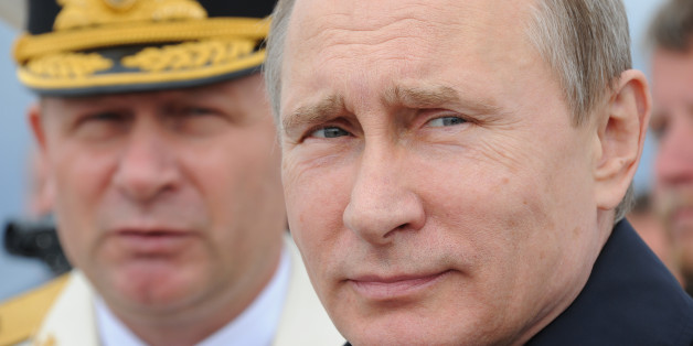 Russian President Vladimir Putin, foreground, reviews a Navy parade inBaltiisk, western Russia, Sunday, July 26, 2015, during celebrations for Russian Navy Day. (Mikhail Klimentyev/RIA-Novosti, Kremlin Pool Photo via AP)