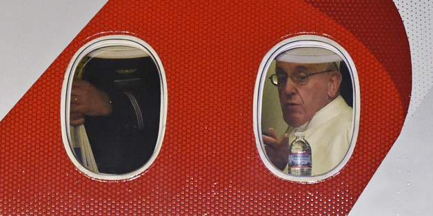 Pope Francis looks out the window a plane as he prepares to depart Philadelphia International Airport in Philadelphia, Sunday, Sept. 27, 2015, on his way back to Rome. Pope Francis wrapped up his 10-day trip to Cuba and the United States on Sunday. (AP Photo/Susan Walsh)