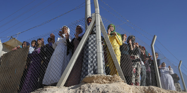 Syrian refugees wait to see the arrival of U.N. High Commissioner for Refugees Antonio Guterres for his visit to the Midyat refugee camp in Mardin, southeastern Turkey, near the Syrian border, Saturday, June 20, 2015. Gutierrez visited the camp which is sheltering those who have fled the 4-year conflict in neighbouring Syria, on the World Refugee Day. The UN refugee agency has said the number of Syrian refugees seeking its help now tops two-million - and could be far higher. Turkey is the world's biggest refugee host with 1.59 million refugees, according to the most recent U.N. figures. (AP Photo/Emrah Gurel)