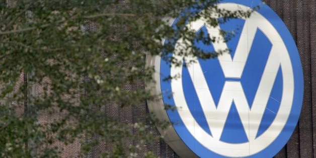 Trees stand in front of giant logo of the German car manufacturer Volkswagen in Wolfsburg, Germany, Saturday, Sept. 26, 2015. (AP Photo/Michael Sohn)