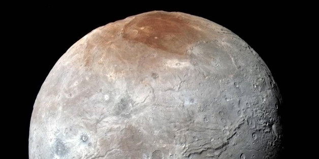 This image released by NASA on Thursday, Oct. 1, 2015, shows Charon, in enhanced color captured by NASA's New Horizons spacecraft just before closest approach on July 14, 2015. Massive canyons and fractures are clearly visible on Charon, which is more than half of Plutoâs size. (NASA/JHUAPL/SwRI via AP)