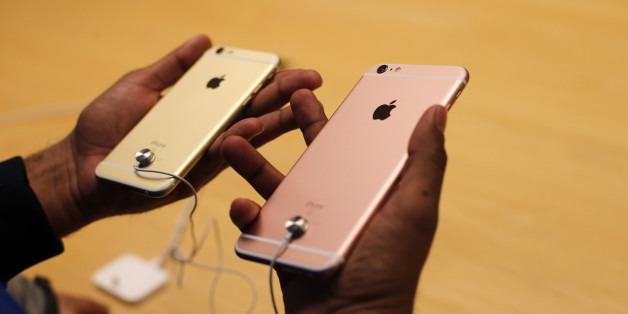 A customer tries out new Apple iPhone 6S at an Apple store on Chicago's Magnificent Mile, Friday, Sept. 25, 2015, in Chicago. (AP Photo/Kiichiro Sato)