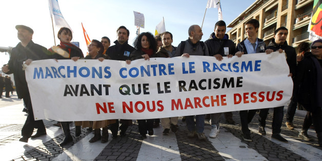 People demonstrate during a march against the racism, in Marseille , southern France, Saturday, Nov. 30, 2013. Banner reads "Let us walk against the racism before the racism walks on us". (AP Photo/Claude Paris)