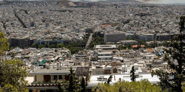 Smoke billows over Athens on July 17, 2015 as firefighters were battling a brush fire in northeastern Athens and another wildfire in the southern Pelopponese peninsula that prompted the evacuation of five villages. More than 120 firefighters had been dispatched to the area, supported by 50 fire engines, four aircraft and two helicopters, officials said.
AFP PHOTO / ANDREAS SOLARO (Photo credit should read ANDREAS SOLARO/AFP/Getty Images)