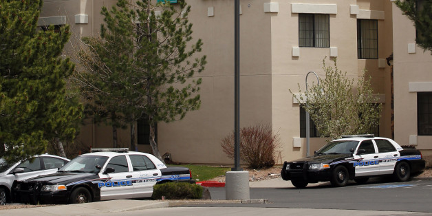 Flagstaff, Ariz., police cars stand Tuesday, May 1, 2012, outside the hotel where Norway's world champion swimmer Alexander Dale Oen was found collapsed on the floor of his bathroom late Monday. Oen, 26, the 100-meter breaststroke world champion, was pronounced dead at Flagstaff Medical Center. Oen was in Flagstaff to train at the Wall Aquatic Center on the campus of Northern Arizona University. (AP Photo/Matt York)