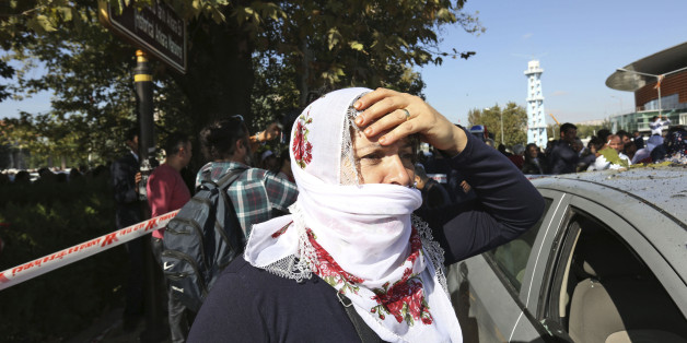 A woman reacts at the site of an explosion in Ankara, Turkey, Saturday, Oct. 10, 2015. Two bomb explosions apparently targeting a peace rally in Turkey's capital Ankara on Saturday has killed over a dozen people, a news agency and witnesses said. The explosions occurred minutes apart near Ankara's train station as people gathered for the rally organized by the country's public sector workers' trade union.(AP Photo/Burhan Ozbilici)
