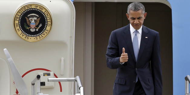 President Barack Obama gives a brief thumbs-up sign as he arrives Friday, Oct. 9, 2015, at King County Airport in Seattle. Obama was in town to attend a pair of fundraisers, following a stop Roseburg, Ore., where he visited families of victims of the shooting rampage there last week. (AP Photo/Elaine Thompson)