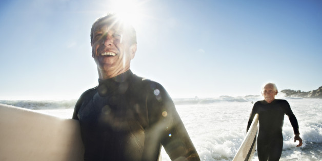 Senior Surfers on beach, close up