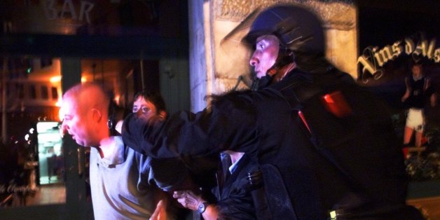 French riot police detain a British soccer fan during riots that errupted in Marseille's Old Port Sunday, June 14, 1998, on the eve of the England vs. Tunisia World Cup soccer game. England, Tunisia, Colombia and Romania are in Group G. (AP Photo/Jerome Delay)