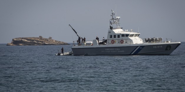 LESBOS ISLAND, GREECE - SEPTEMBER 20: Greek Coast Guard rescue passengers of a capsized boat carrying refugees in the Aegean Sea near the coast of Lesbos Island, Greece on September 20, 2015. (Photo by Ozge Elif Kizil/Anadolu Agency/Getty Images)