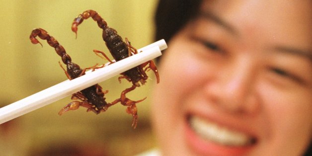 --Singaporean diner Sum June-wei holds two scorpions between her chopsticks at the Imperial Herbal Restaurant in Singapore Jan. 25, 1996. The scorpions, imported from China, cost $4 each in a dish called "deep-fried drunken scorpion with asparagus." Customers are told that the scorpion's poison soothes nerves and cures migraine. (AP Photo/Mike Fiala)