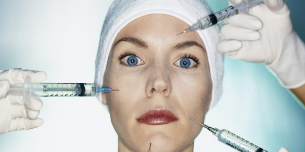 Mixed race woman having facial injections
