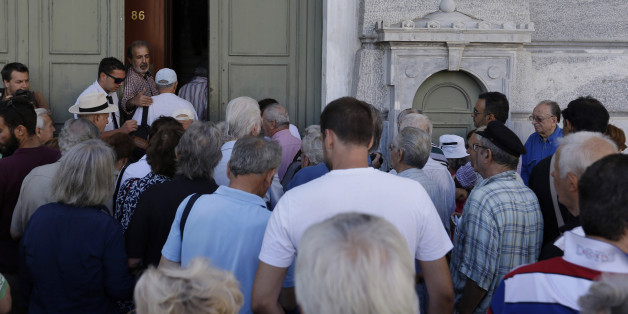 The first customers, most of them pensioners, stand in a queue to enter a branch at National Bank of Greece headquarters in Athens, Monday, July 20, 2015. Greek banks reopen on Monday morning, but many restrictions on transactions, including cash withdrawals, will remain. Also, many goods and services will become more expensive as a result of a rise in Value Added Tax approved by Parliament last Thursday, among the first batch of austerity measures demanded by Greece's creditors. (AP Photo/Thanassis Stavrakis)