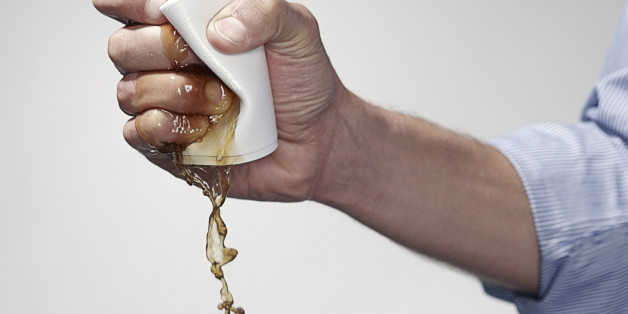 Hand holding a cup of coffee