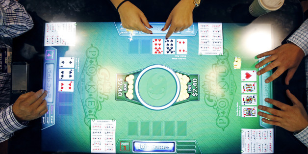 People try out Grab Poker, a skill-based gaming machine, at the Gamblit booth during the Global Gaming Expo on Tuesday, Sept. 29, 2015, in Las Vegas. The convention, geared for the gaming industry, runs through Oct. 1. (AP Photo/John Locher)