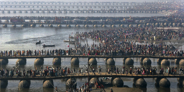 FILE - In this Feb. 10, 2013 file photo, Hindu devotees walk across pontoon bridges to take a holy dip at Sangam, the confluence of the Ganges, Yamuna and mythical Saraswati River, during the Maha Kumbh festival, in Allahabad, India. Philippine officials estimate that as many as 6 million people will attend the Mass that Pope Francis celebrates Sunday, Jan. 18, 2015 in Manilaâs Rizal Park. That would be a record for any pope, but not for any event. A look at some of the biggest gatherings of humanity: (AP Photo/Manish Swarup, File)