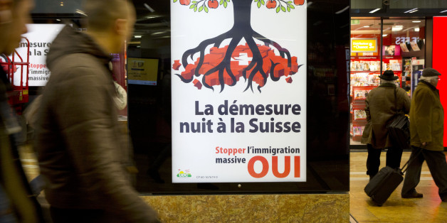 Pedestrians pass by an election poster from the nationalist Swiss Peopleâs Party, demanding a stop for immigration to Switzerland at the train station in Geneva, Switzerland, Friday, Feb. 7, 2014. Swiss voters are being asked to decide on a proposal Feb. 9, 2014 to cap immigration to the Alpine republic, a long-standing demand of Switzerlandâs most powerful party. (AP Photo/Anja Niedringhaus)
