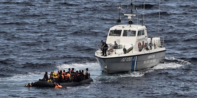 A Hellenic coast guard rescues refugees and migrants on a dinghy as they try to reach the Greek island of Lesbos while crossing the Aegean sea from Turkey on September 29, 2015. More than half a million migrants and refugees have crossed the Mediterranean to Europe so far this year -- 383,000 of them arriving in Greece, the United Nations said. AFP PHOTO / ARIS MESSINIS (Photo credit should read ARIS MESSINIS/AFP/Getty Images)