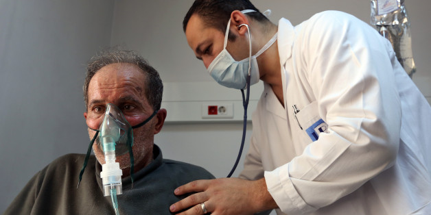 A Lebanese man, who suffers breathing problems caused by a sandstorm, breathes through an oxygen mask as he receives treatment by a doctor, in the Bekaa valley, eastern Lebanon, Tuesday, Sept. 8, 2015. The unseasonal sandstorm hit Lebanon and Syria, covering Beirut and Damascus with a blanket of yellow dust on Tuesday, sending hundreds of people to hospitals with breathing difficulties and causing the deaths of two women, officials said. (AP Photo/Bilal Hussein)