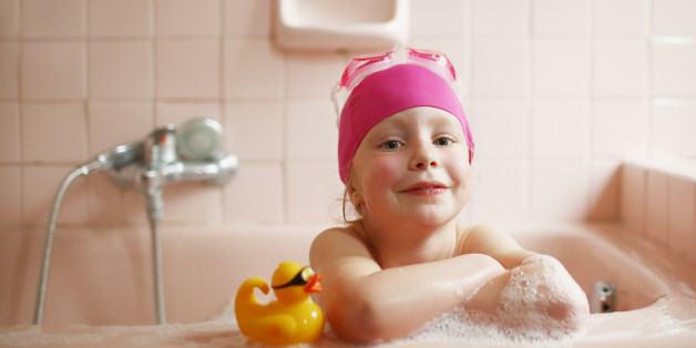 A 5 years old girl taking her bath
