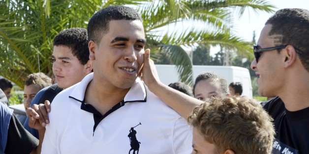 FILE - In this Sept. 26, 2013 file photo, Tunisian rapper, Ahmed Ben Ahmed, known as Klay BBJ, left, is surrounded by supporters as he arrives at the court house in the coastal town of Hammamet, Tunisia. Tunisiaâs youth are still feeling sidelined, and just like the days of dictatorship, one of the few ways they are getting their voices heard outside their towns and neighborhoods is through hip hop, shouting to anyone who will listen that all is not well in Tunisia. âPeople are still b