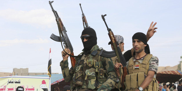 Sunni volunteer fighters parade as they prepare to support Iraqi security forces in liberating the city of Ramadi from Islamic State group militants, in Khalidiya, 60 miles (100 kilometers) west of Baghdad, Iraq, Saturday, Oct. 10, 2015. (AP Photo/Karim Kadim)