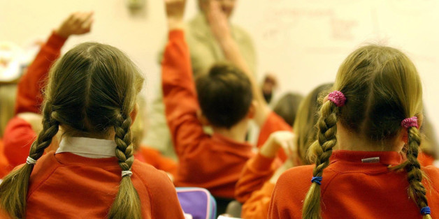 photo dated 03/12/2003 showing primary school pupils during a lesson. A battery of Government initiatives has reduced children to the status of "targets and outputs" in a school system ruled by political "whim", researchers warned today.