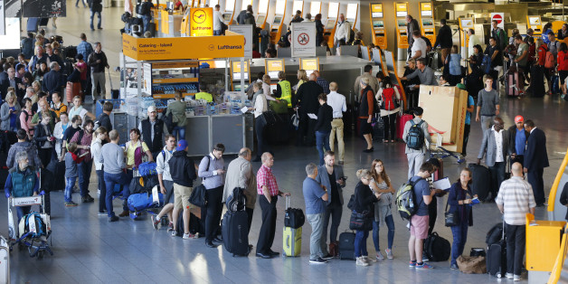 Passengers queue in front of the counters in a terminal at the airport as Lufthansa pilots went on a strike in Frankfurt, Germany, Wednesday, Sept. 9, 2015. The pilots ask for retirement arrangement under which pilots could retire at 55 and receive 60 percent of their salary until they reach the statutory retirement age of 65. (AP Photo/Michael Probst)