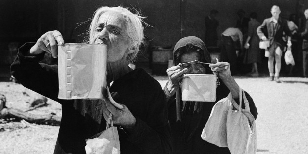 When the islands of Rhodes, in the Aegean, was liberated from the Nazi Yoke, the British military administration was faced with the problem of feeding the starving population men, women and children suffering from the effects of malnutrition caused by insufficient food during the Nazi occupation. In a very short time a tribute of British organization and administration the people had been issued with ration books and essential food was being distributed. Nourishing soup was issued from Red Cross coup kitchens. Two old women sip the soup as they leave on June 13, 1945. They have shopping bags with them so they can call afterwards for their food rations. (AP Photo)