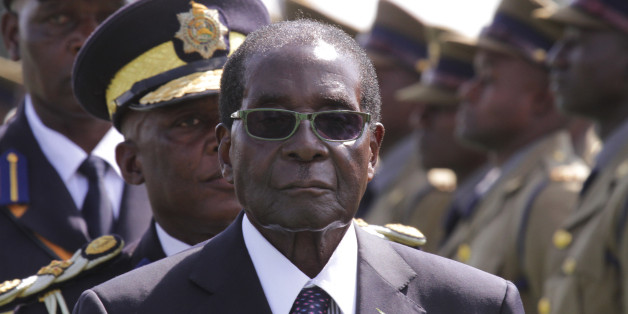 FILE - In this Thursday, May 14, 2015 file photo, Zimbabwean President Robert Mugabe, centre, officiates at the Presidential Graduation ceremony of police officers at the general police headquarters, in Harare, Zimbabwe. The African president has his firmly hands on the reins of government at home and is frequently on the move, flying around the globe. At age 91, Zimbabwe's President Robert Mugabe shows few signs of slowing down. (AP Photo/Tsvangirayi Mukwazhi, File)